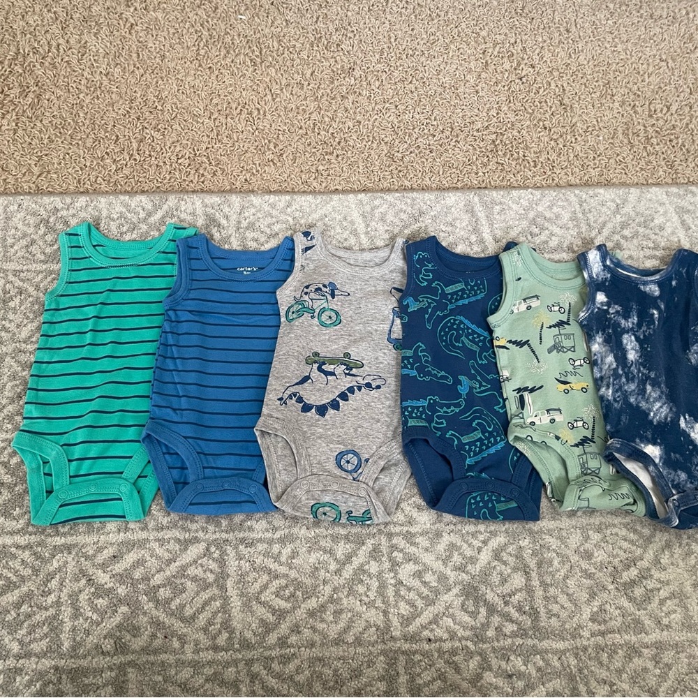 Up for sale are six sleeveless onesies by Carter's in a size 3 months.